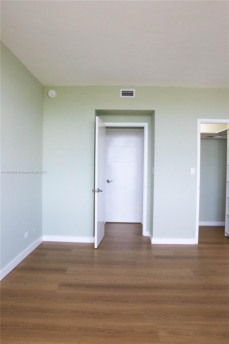 North Beach Miami Beach, FL 33141 - Photo 10 of 30 a view of an empty room with wooden floor & closet