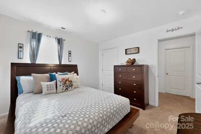 a bedroom with a bed and cabinet