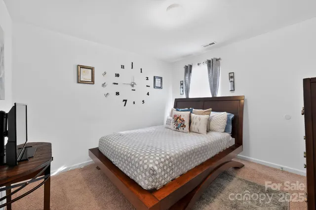 a bedroom with a bed and flat screen tv