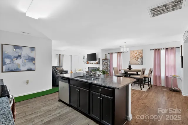 a kitchen with sink cabinets and dining table