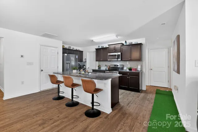 a kitchen with a sink cabinets and wooden floor