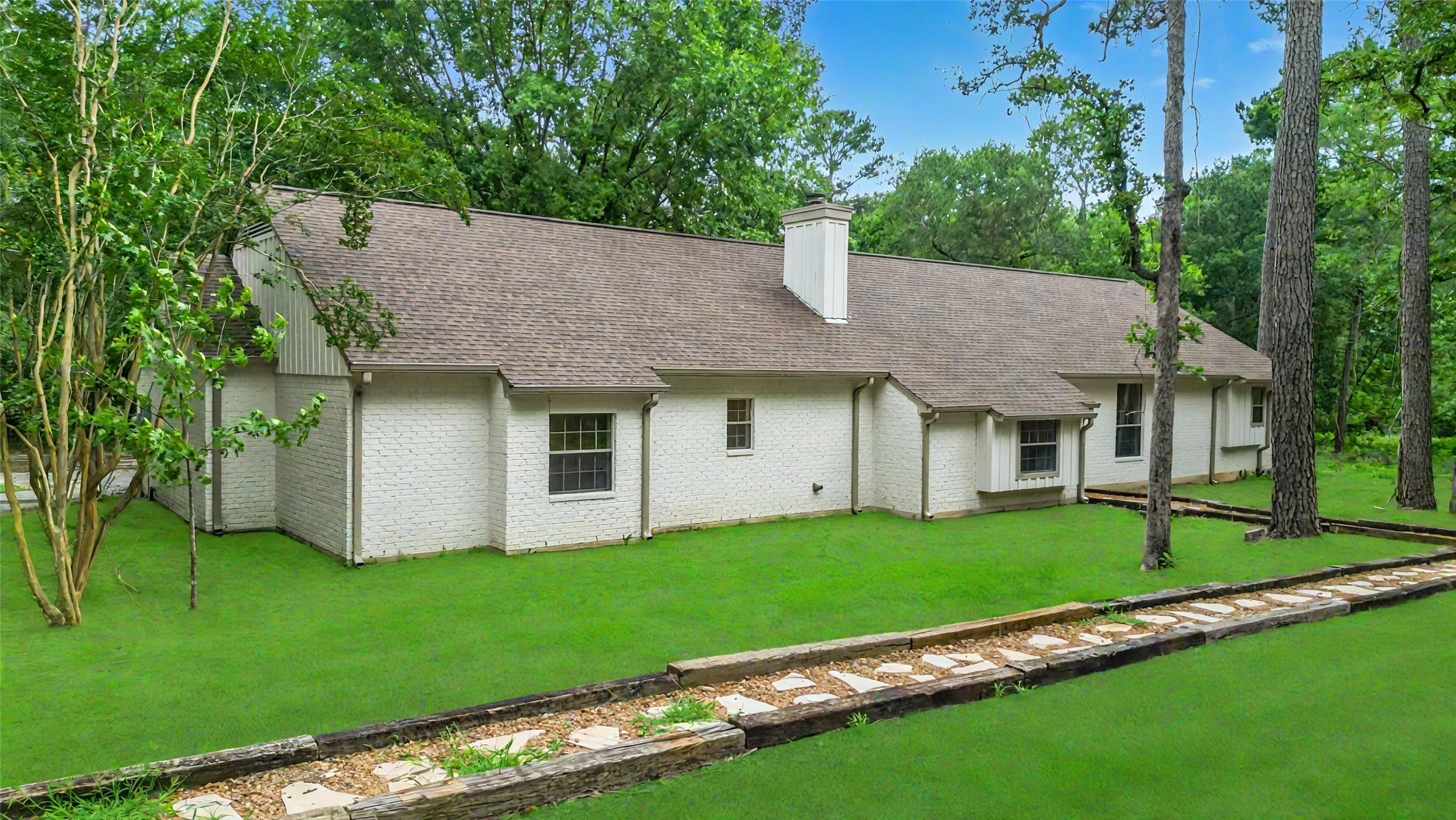 83 Dahlia Road Huntsville, TX 77320 - Photo 2 of 49 a front view of a house with a garden