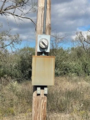 a view of a yard with a wooden fence