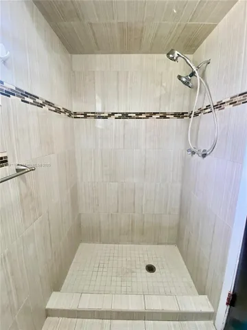 a bathroom with a shower and a shower