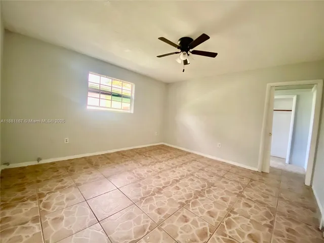 a view of a big room with wooden floor closet and windows