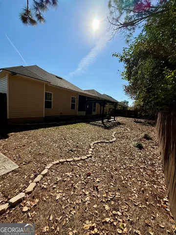 a backyard of a house with table and chairs