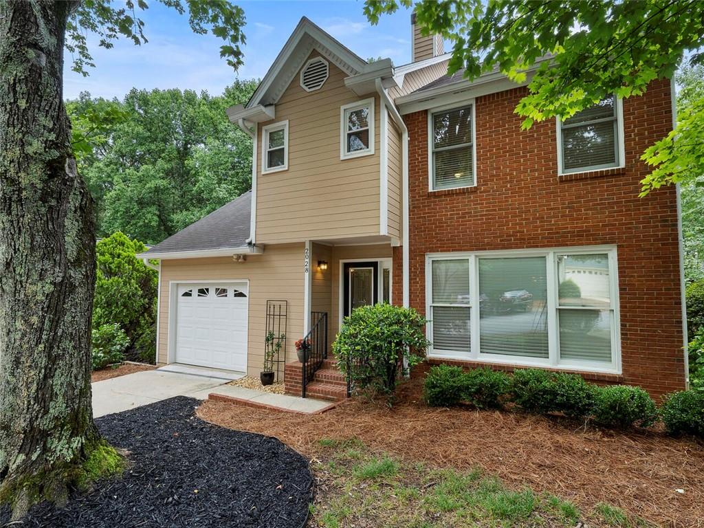 a front view of a house with a yard and a garage