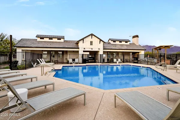 a view of a house with swimming pool and sitting area