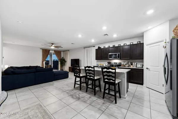 a kitchen with stainless steel appliances wooden cabinets a sink and a refrigerator