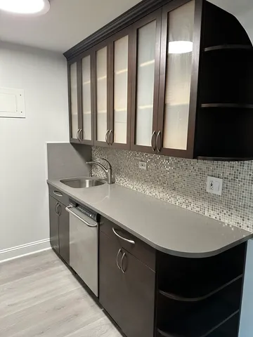 a stove top oven sitting inside of a kitchen