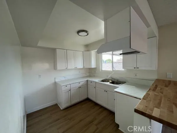 a kitchen with granite countertop a sink and cabinets