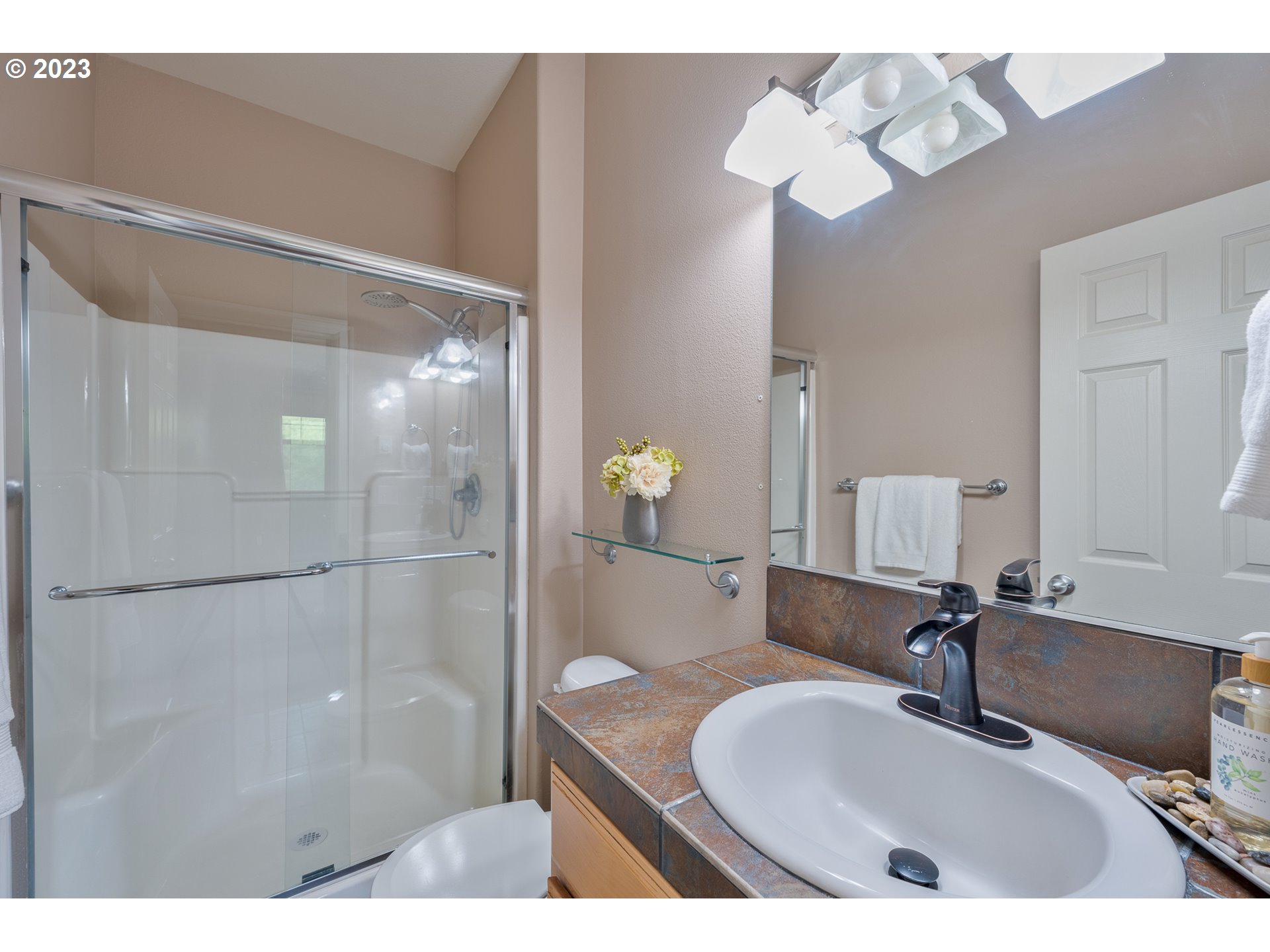 17335 Ruben Lane, Unit 19 Sandy, OR 97055 - Photo 13 of 27 a bathroom with a sink vanity and a mirror