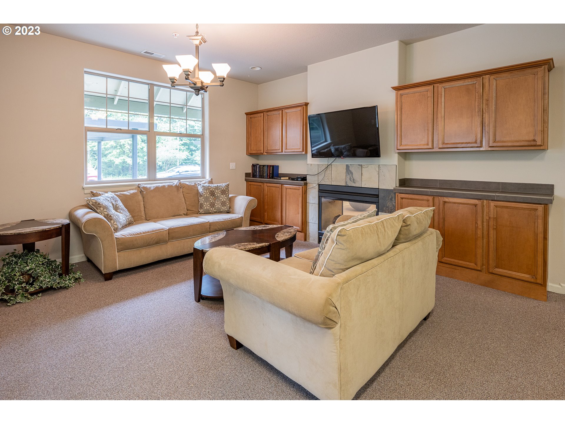 17335 Ruben Lane, Unit 19 Sandy, OR 97055 - Photo 23 of 27 a living room with furniture a flat screen tv and kitchen view