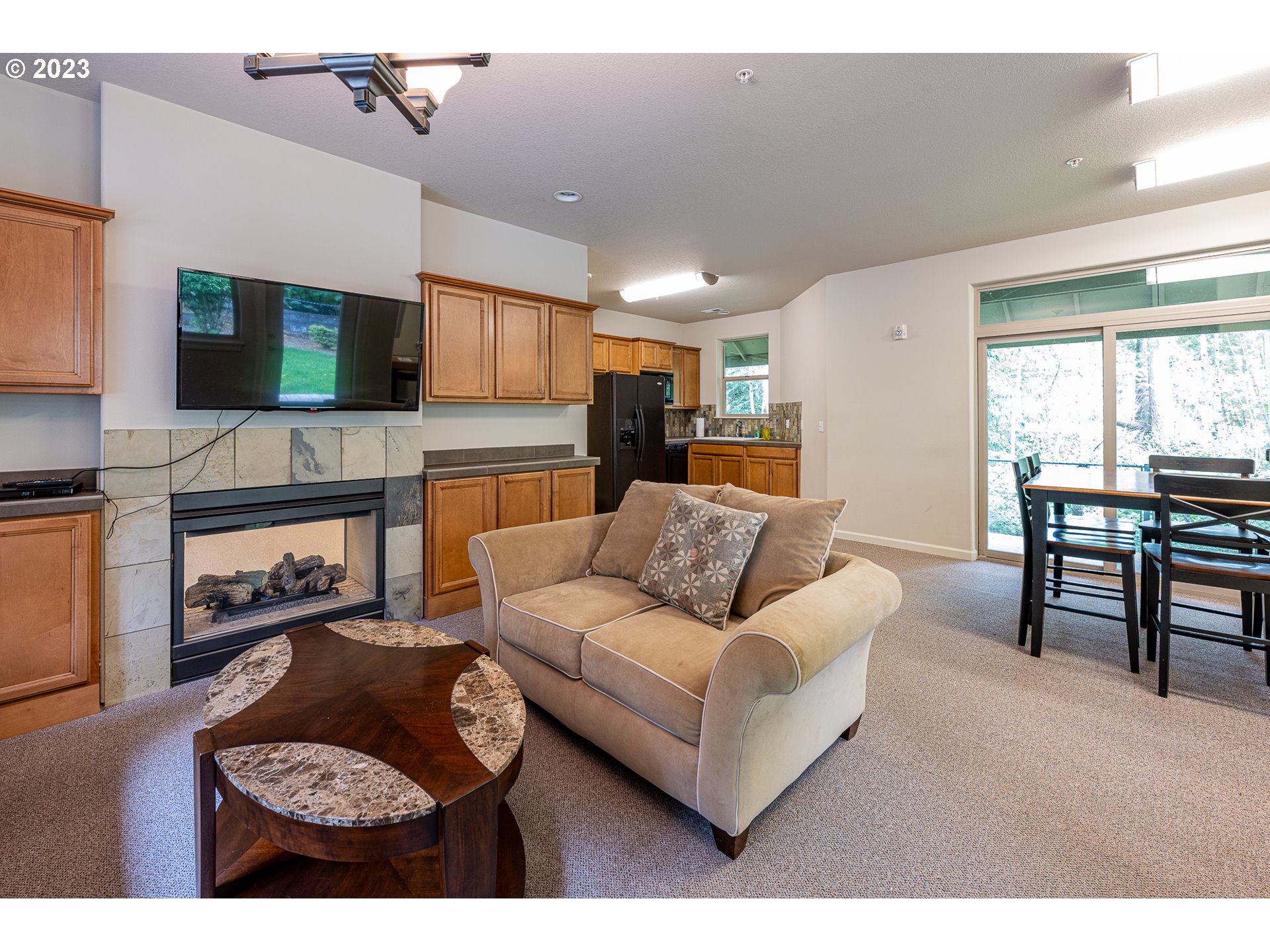17335 Ruben Lane, Unit 19 Sandy, OR 97055 - Photo 24 of 27 a living room with furniture a flat screen tv and a fireplace