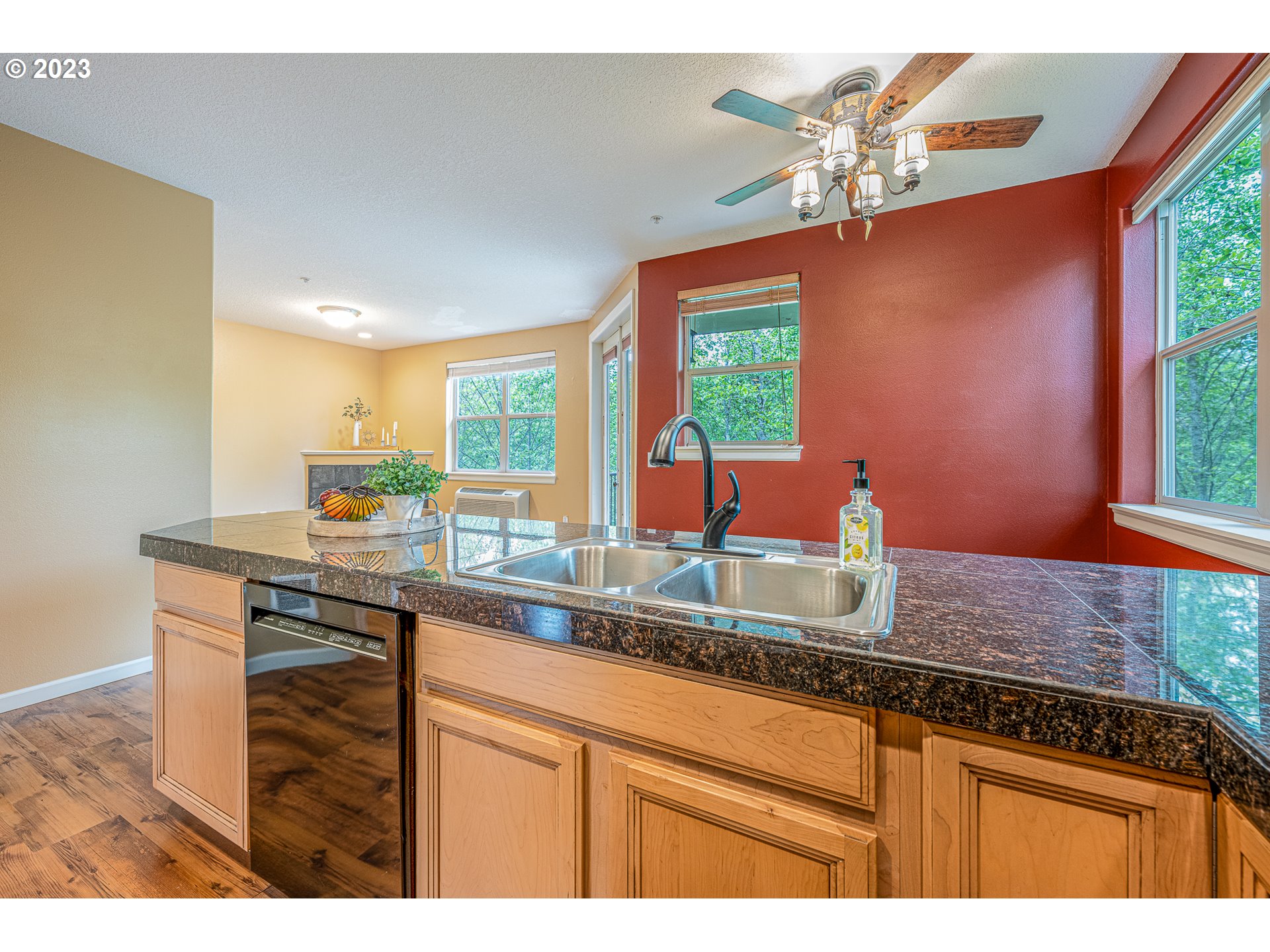17335 Ruben Lane, Unit 19 Sandy, OR 97055 - Photo 6 of 27 a kitchen with stainless steel appliances granite countertop a sink a counter space and a window