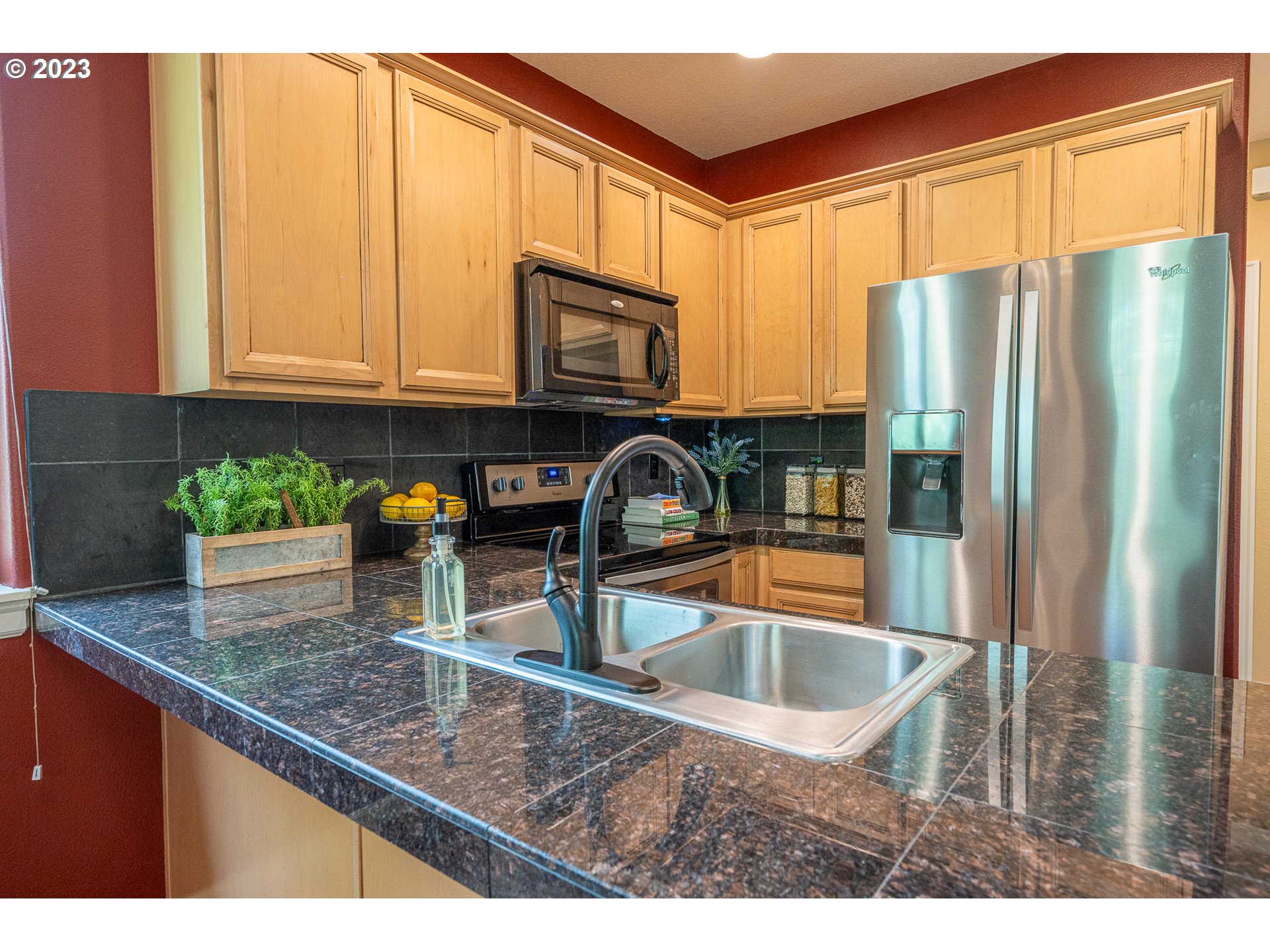 17335 Ruben Lane, Unit 19 Sandy, OR 97055 - Photo 7 of 27 a kitchen with granite countertop a sink a refrigerator and a granite counter tops