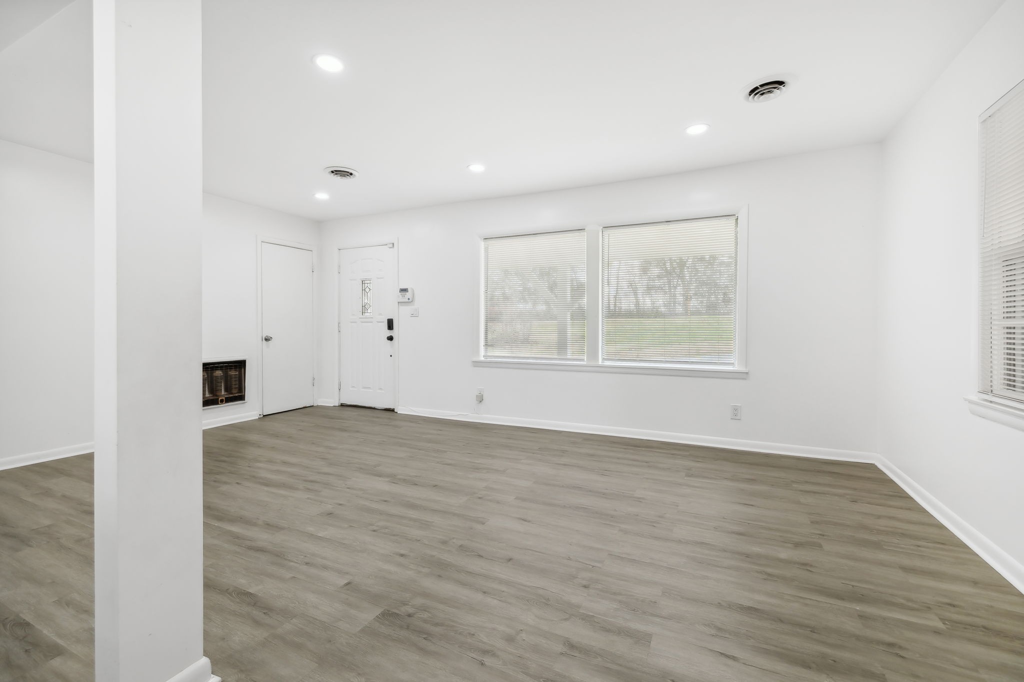 1108 Lock 4 Road Gallatin, TN 37066 - Photo 12 of 49 an empty room with wooden floor and windows