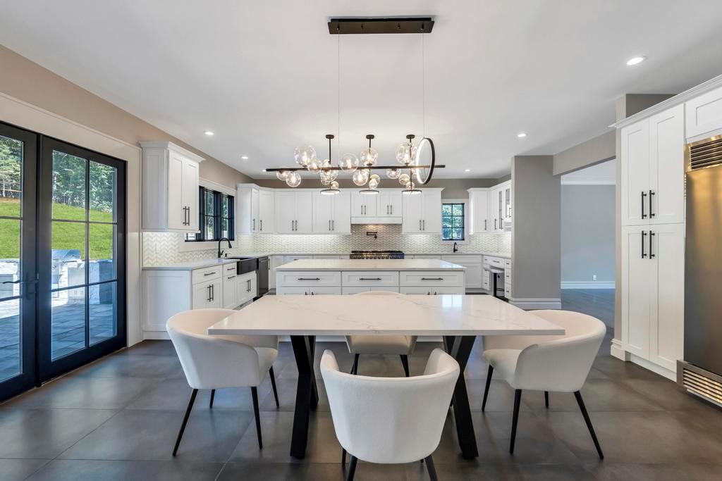 589 Old Bridge Road Northport, NY 11768 - Photo 16 of 40 a large kitchen with dining table and chairs