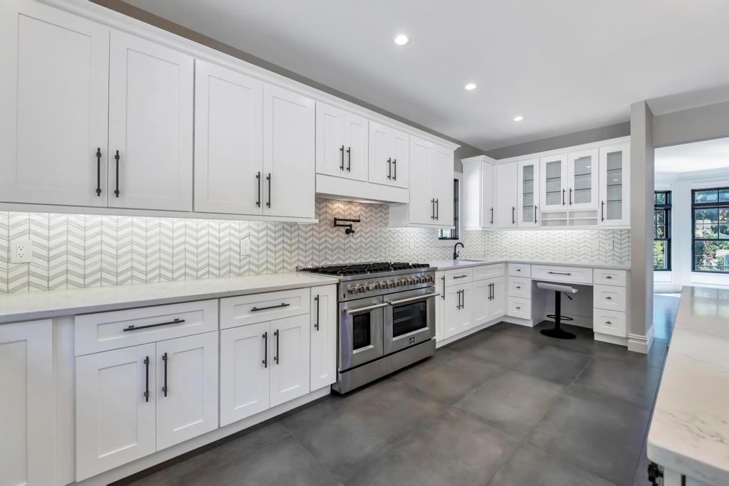 589 Old Bridge Road Northport, NY 11768 - Photo 20 of 40 a kitchen with granite countertop white cabinets and white appliances