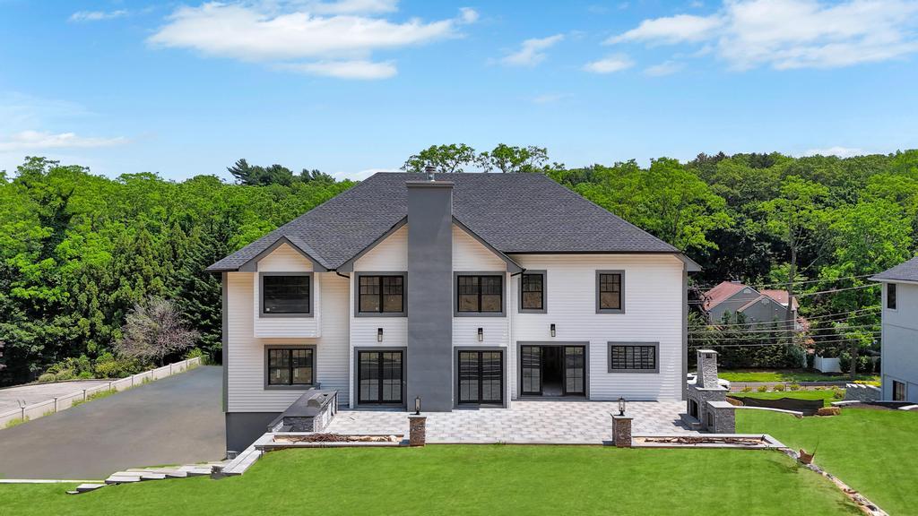 589 Old Bridge Road Northport, NY 11768 - Photo 2 of 40 a front view of a house with a yard