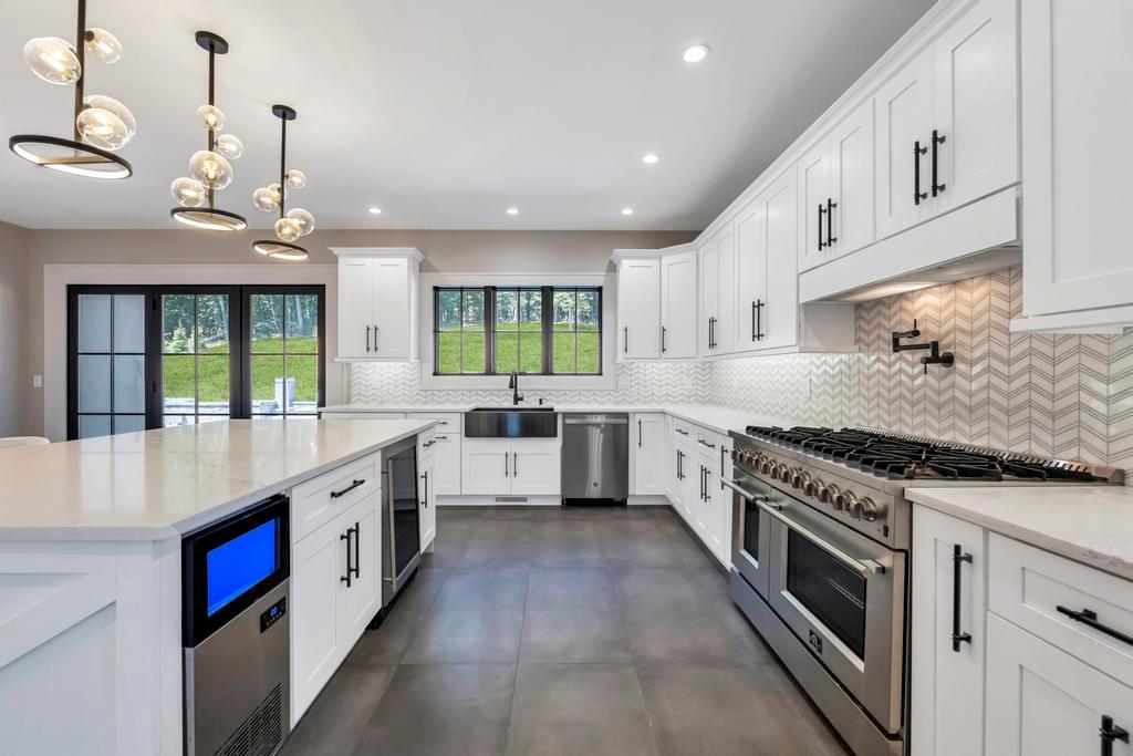 589 Old Bridge Road Northport, NY 11768 - Photo 21 of 40 a large kitchen with stainless steel appliances granite countertop a stove and a sink