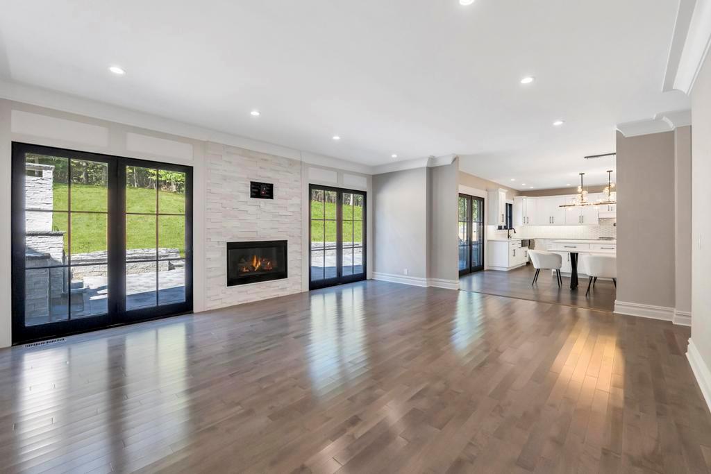 589 Old Bridge Road Northport, NY 11768 - Photo 24 of 40 an empty room with wooden floor and a fireplace