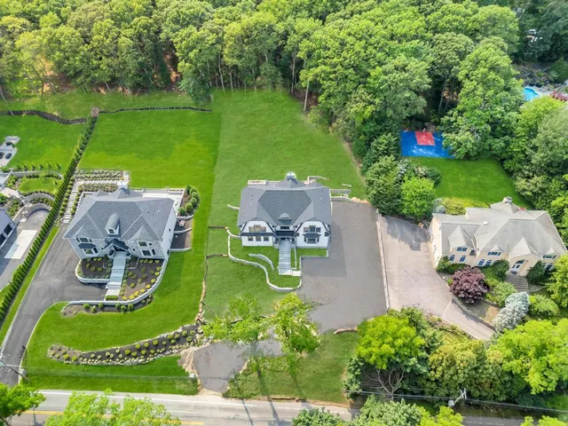 an aerial view of a house with garden space and outdoor seating
