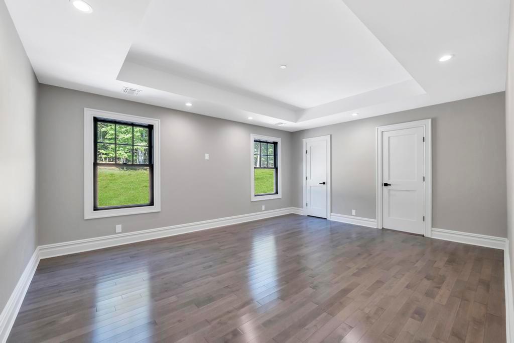 589 Old Bridge Road Northport, NY 11768 - Photo 33 of 40 an empty room with wooden floor and windows