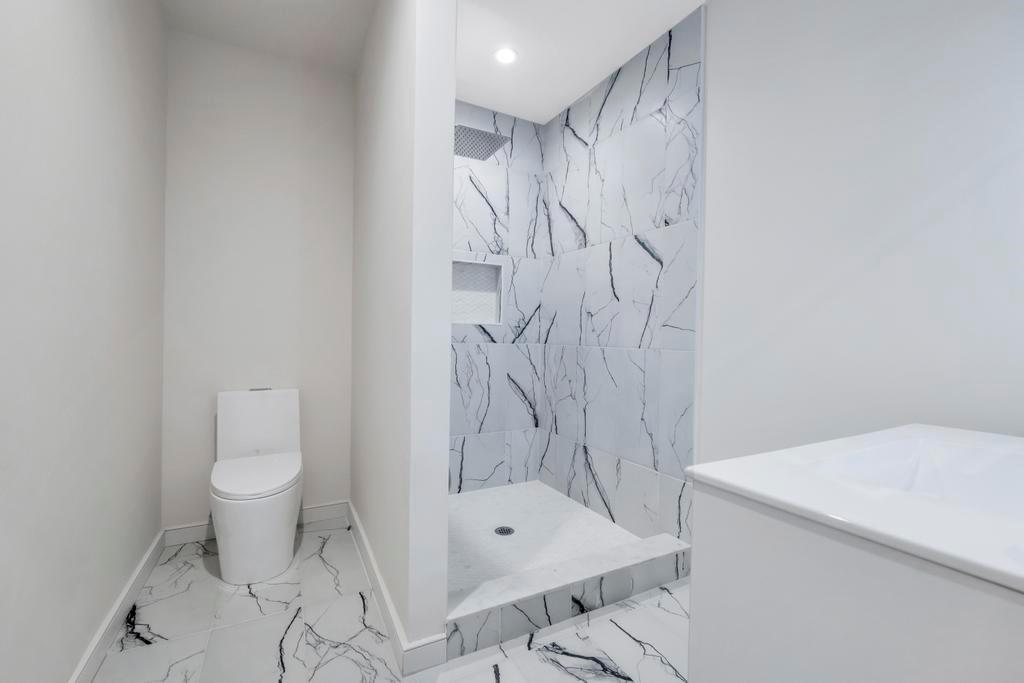 589 Old Bridge Road Northport, NY 11768 - Photo 39 of 40 a bathroom with a toilet sink and shower