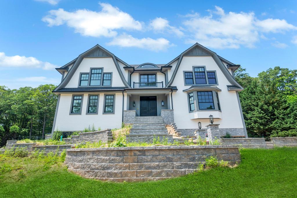 589 Old Bridge Road Northport, NY 11768 - Photo 8 of 40 a front view of house with yard and trees in the background