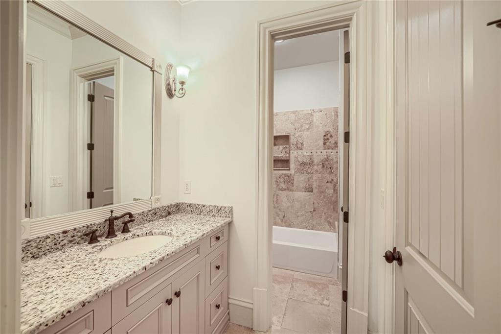 7965 Robin Road Cumming, GA 30041 - Photo 39 of 64 a bathroom with a granite countertop sink and a mirror