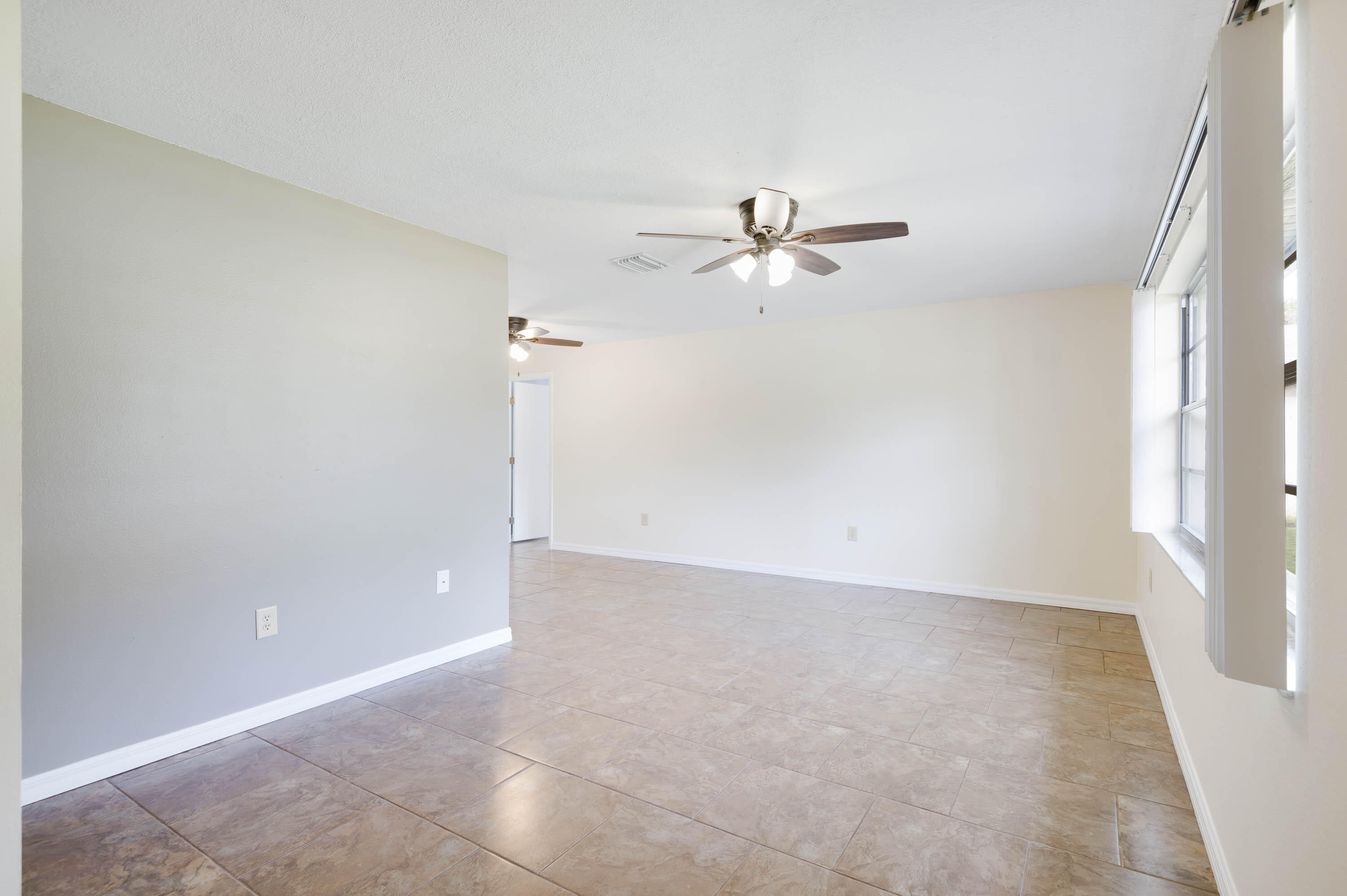 2331 Scotland Road Cocoa, FL 32926 - Photo 12 of 20 an empty room with fan and entrance