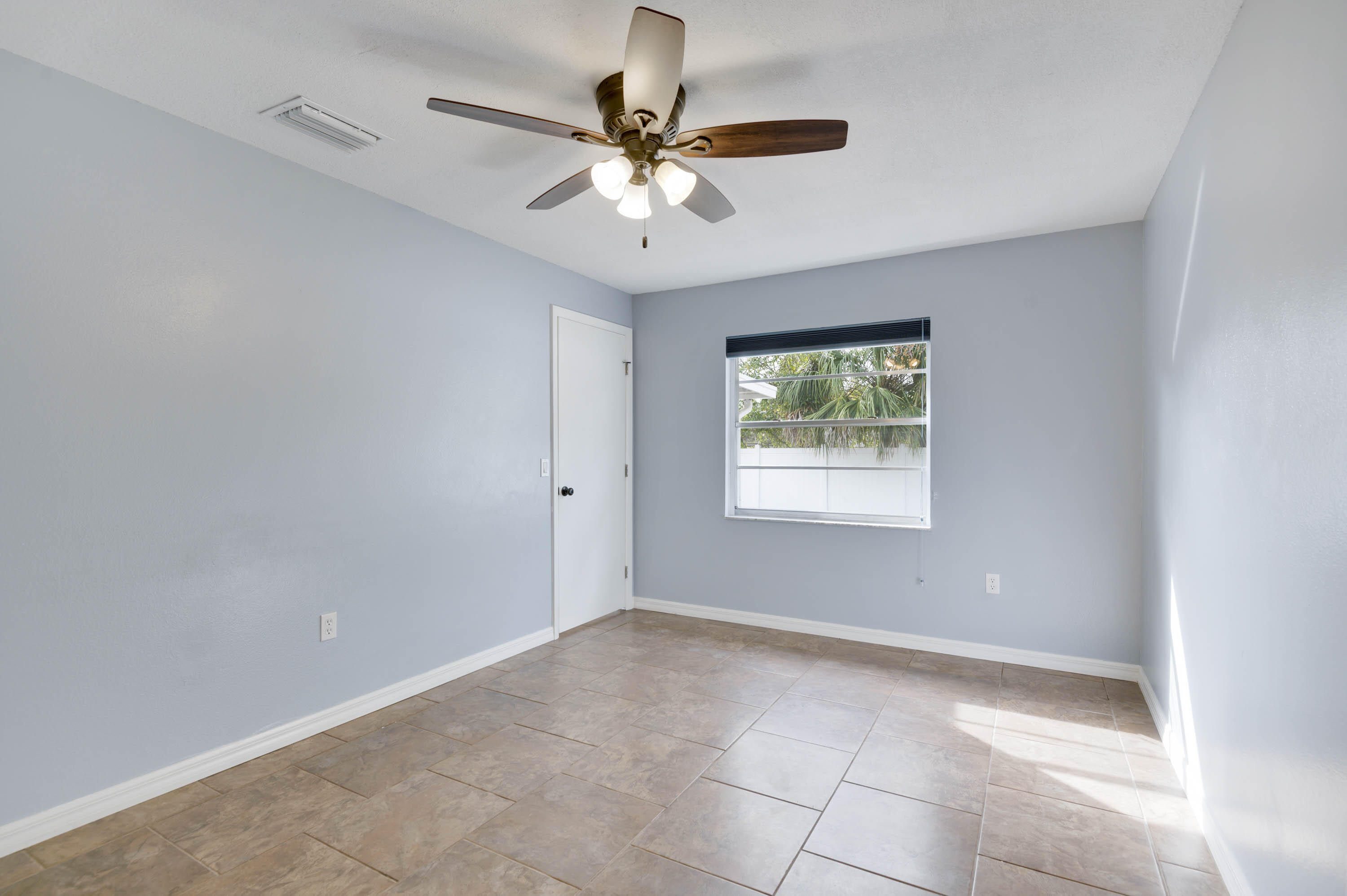 2331 Scotland Road Cocoa, FL 32926 - Photo 14 of 20 an empty room with a window and a fan