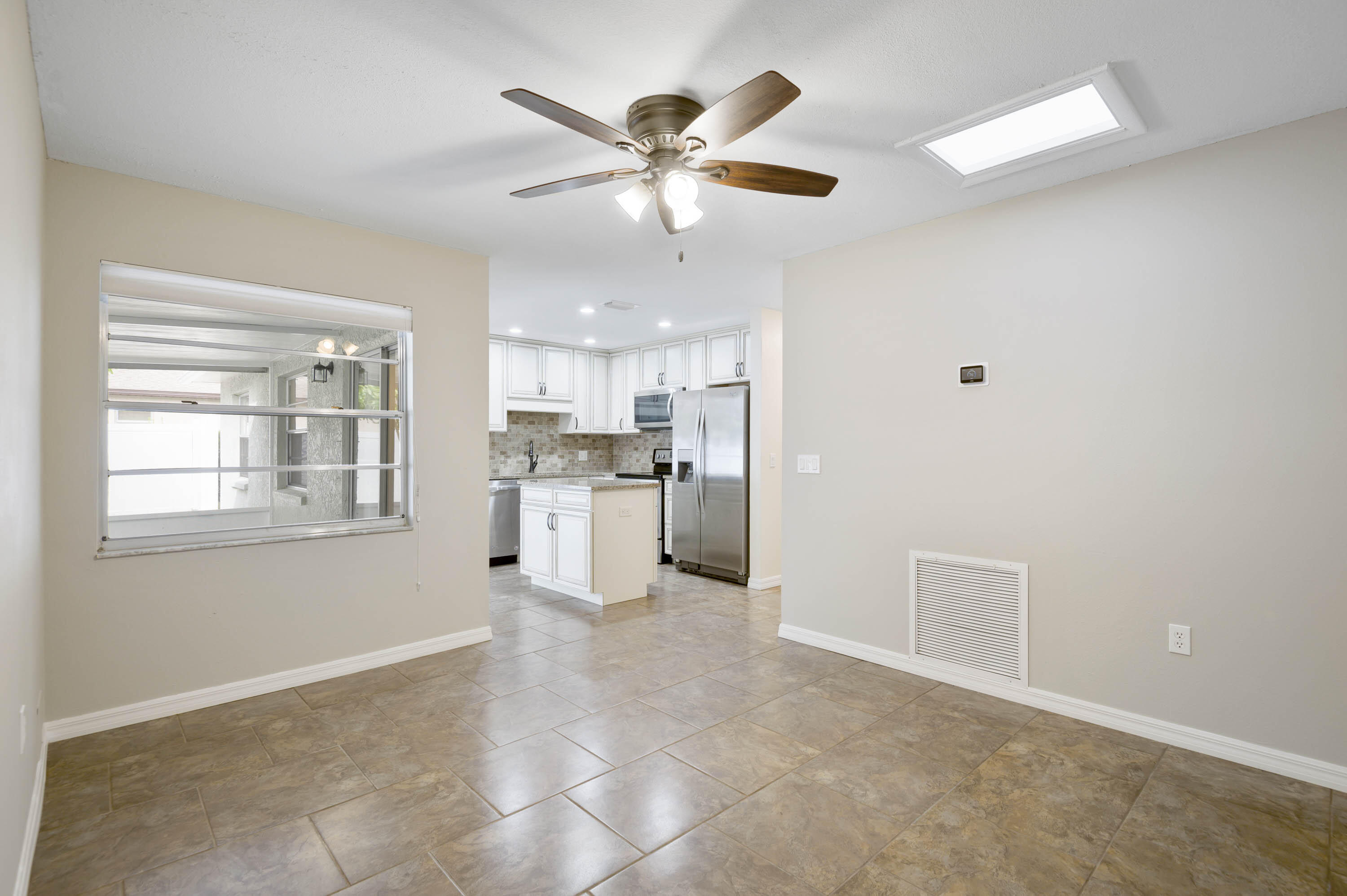 2331 Scotland Road Cocoa, FL 32926 - Photo 6 of 20 a view of an empty room with window and cabinet