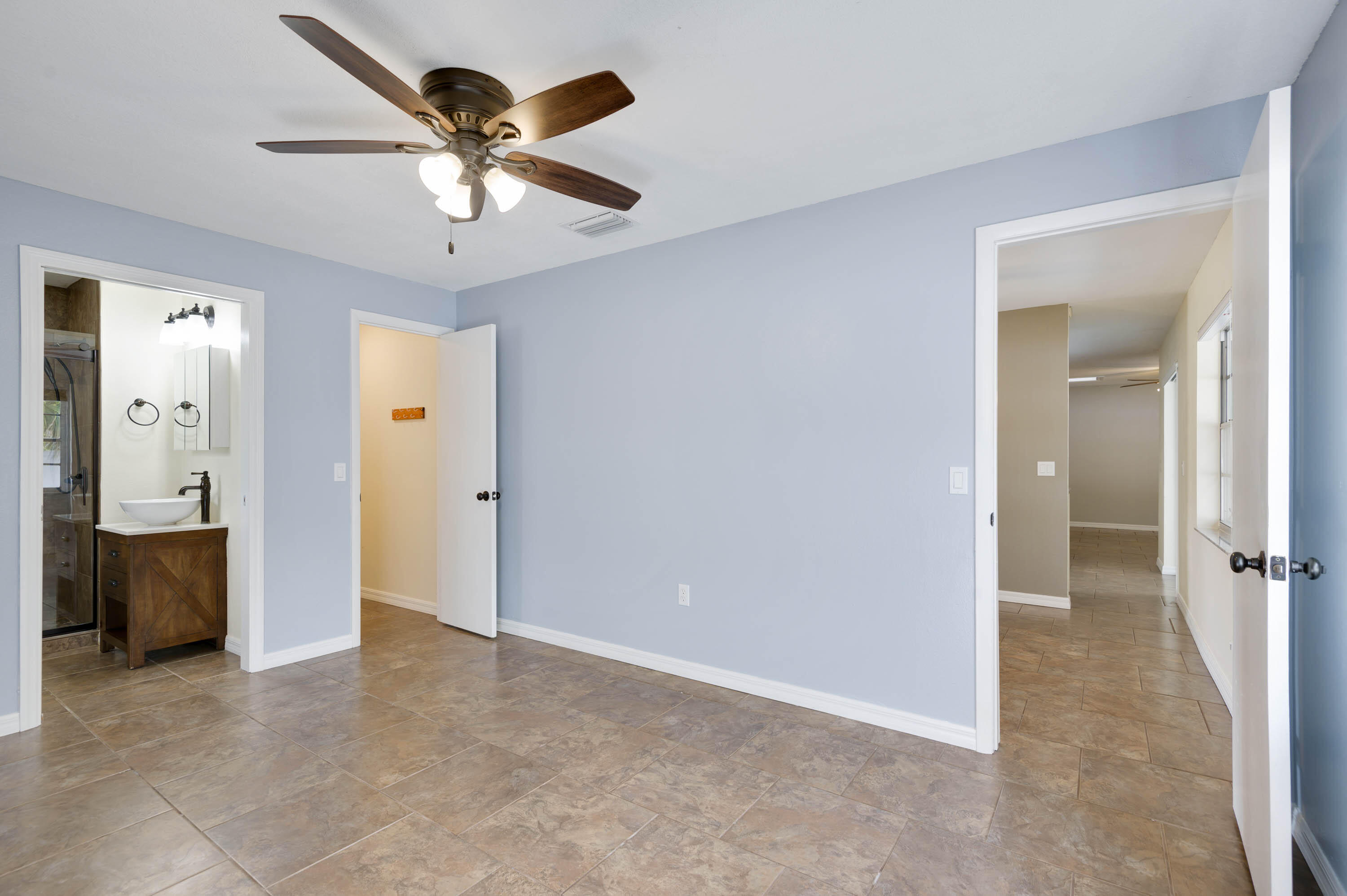 2331 Scotland Road Cocoa, FL 32926 - Photo 7 of 20 wooden floor in an empty room and a ceiling fan