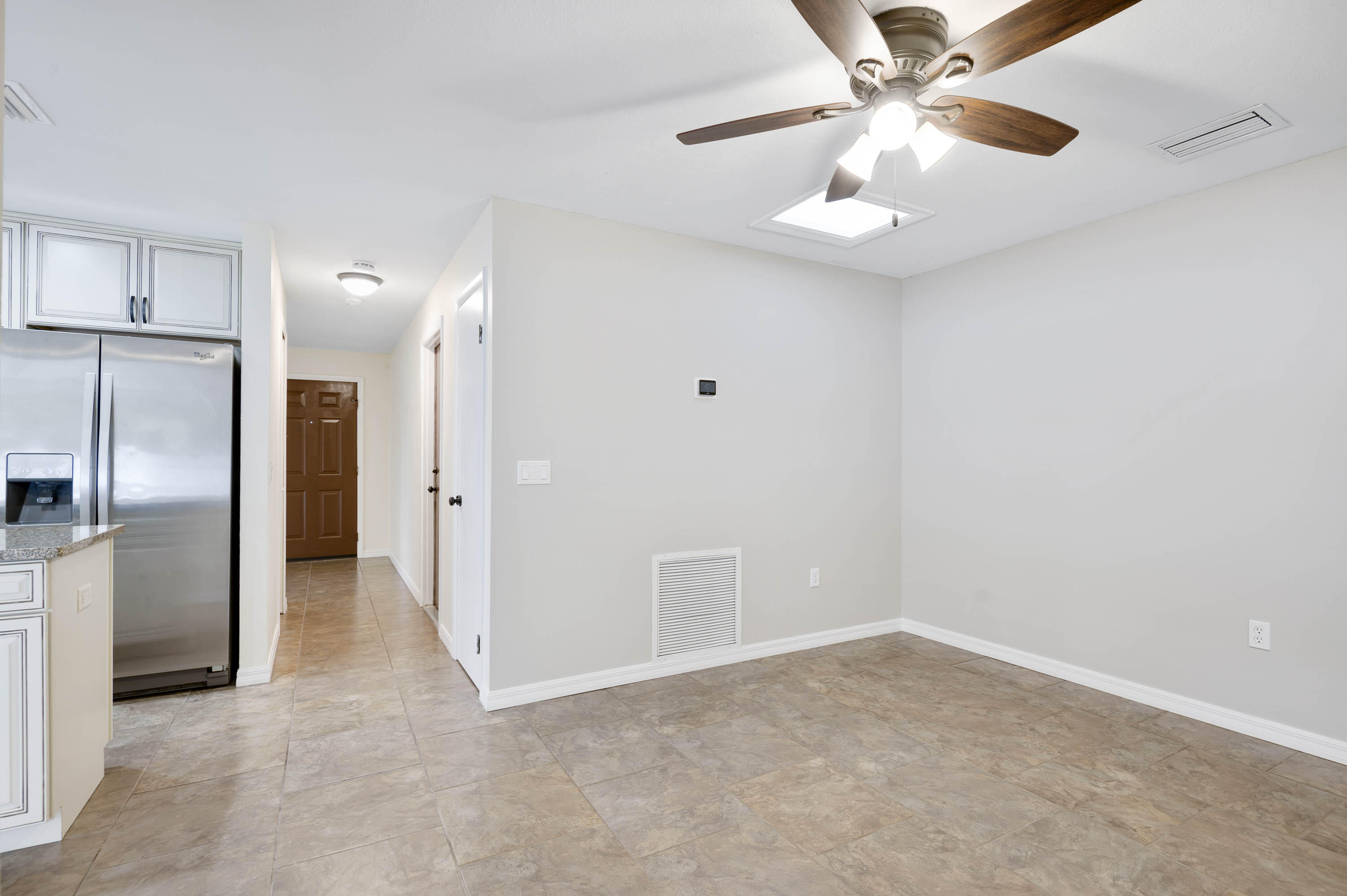 2331 Scotland Road Cocoa, FL 32926 - Photo 9 of 20 an empty room with chandelier fan and refrigerator