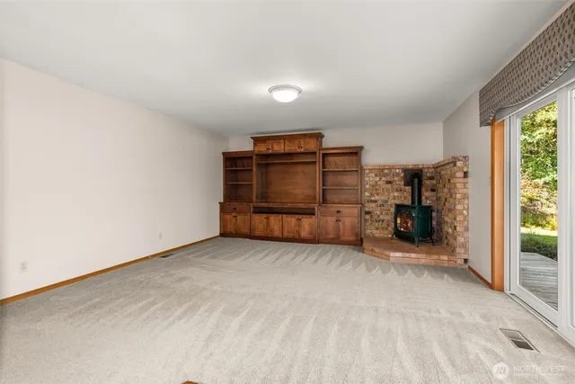 an empty room with furniture and a window