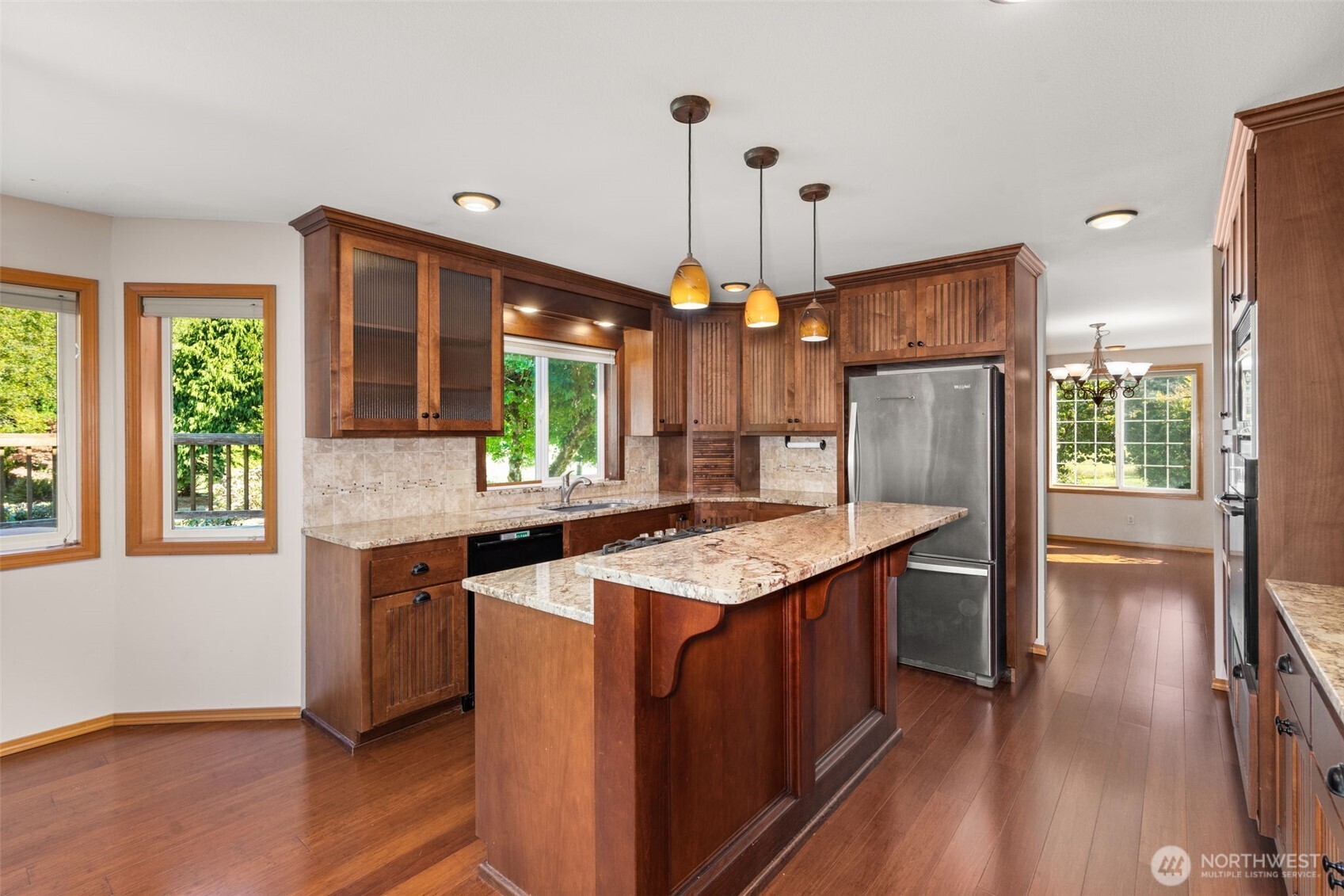 125 Mill Creek Road Raymond, WA 98577 - Photo 14 of 40 a kitchen with stainless steel appliances granite countertop wooden floors and sink