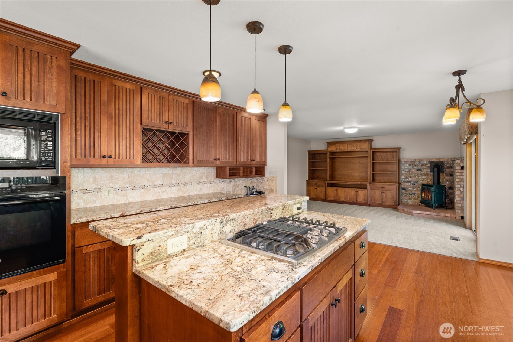 125 Mill Creek Road Raymond, WA 98577 - Photo 16 of 40 a kitchen with a stove a sink a refrigerator and wooden cabinets