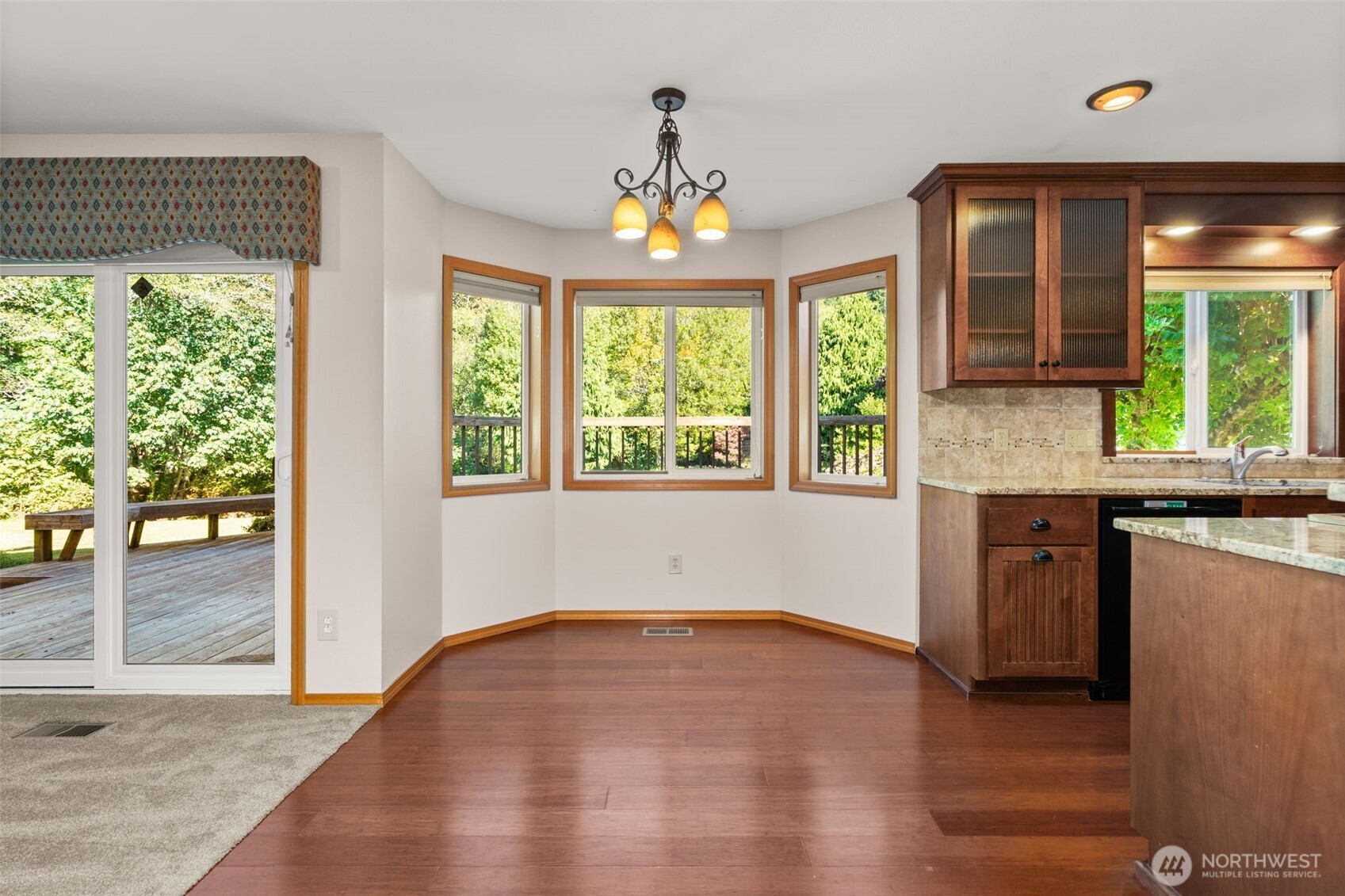 125 Mill Creek Road Raymond, WA 98577 - Photo 17 of 40 an empty room with wooden floor chandelier and windows