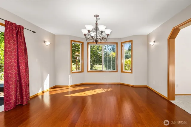 a view of a livingroom with wooden floor and a window