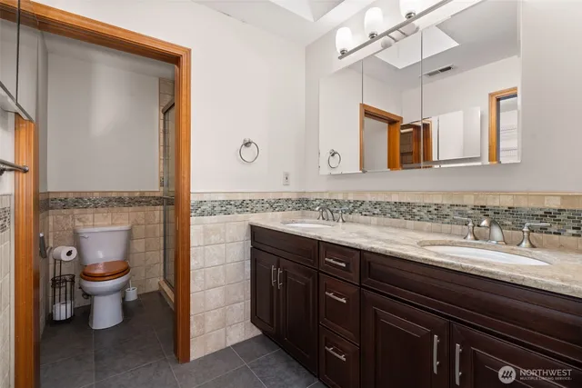 a spacious bathroom with a granite countertop sink and a mirror
