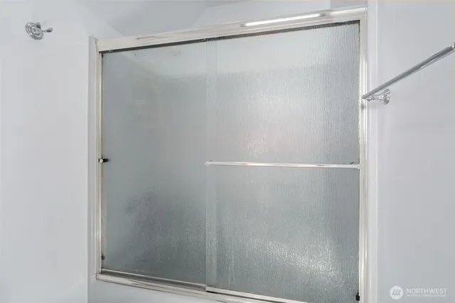 a bathroom with a glass shower door