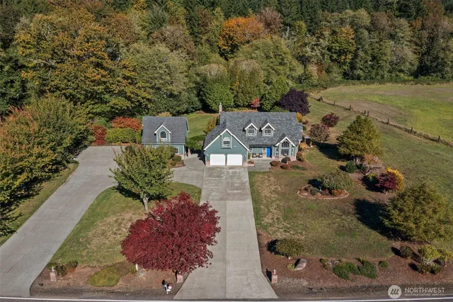 an aerial view of a house with a yard