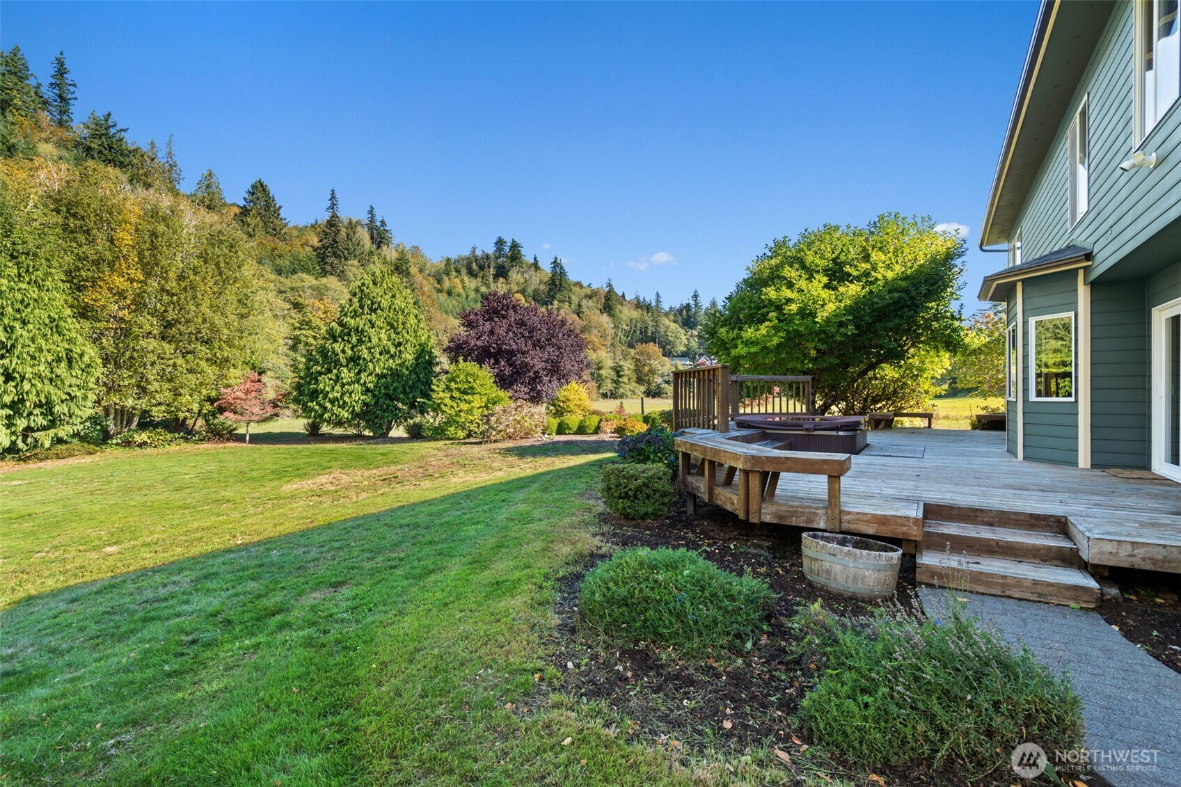 125 Mill Creek Road Raymond, WA 98577 - Photo 38 of 40 a view of a bench in the garden near a house