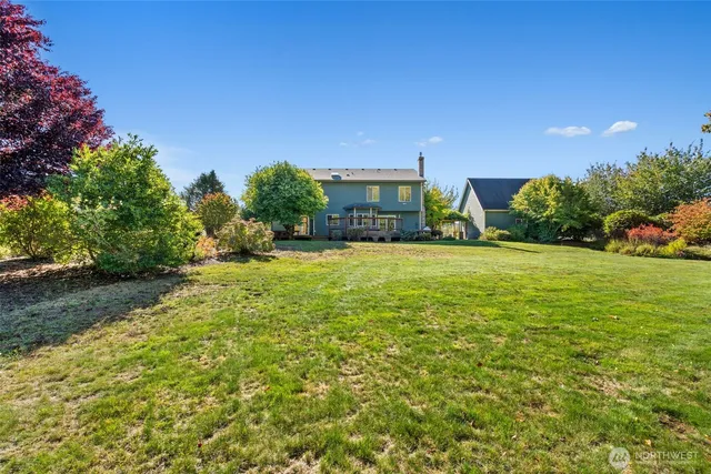 a view of a house with a yard and garage