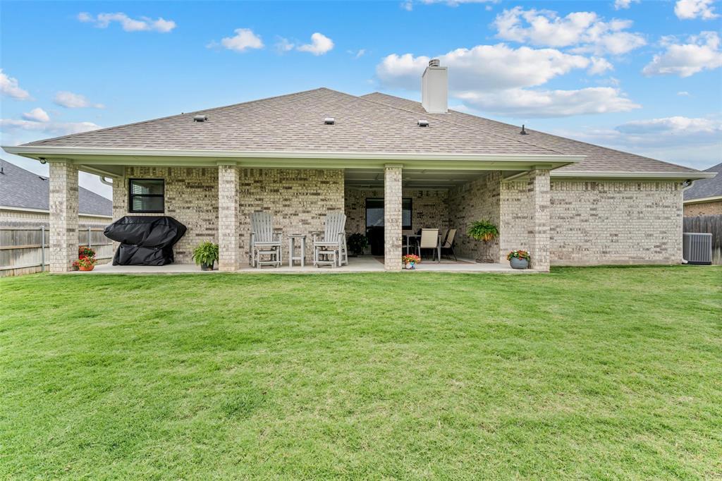 828 Agile Street Hewitt, TX 76643 - Photo 30 of 30 a view of a house with backyard and porch