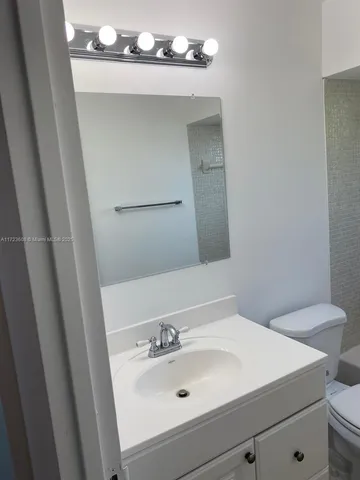 a bathroom with a sink a shower and a mirror