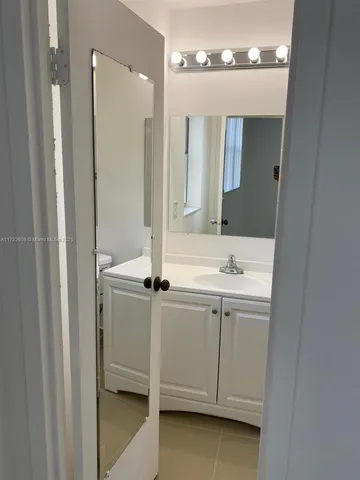 a white toilet sitting next to a shower