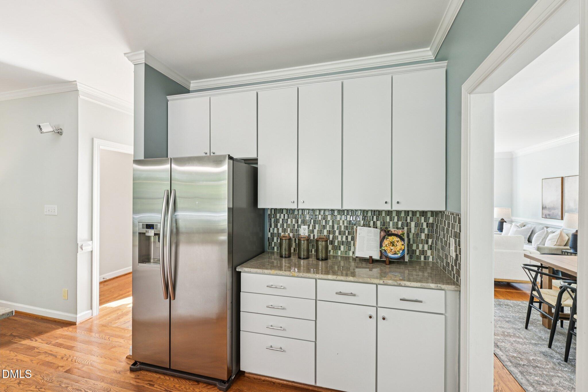 3008 Walton Heath Court Raleigh, NC 27612 - Photo 16 of 57 a kitchen with stainless steel appliances granite countertop a refrigerator a sink and white cabinets